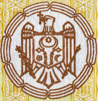 Old Muscat, Oman: national emblem of Oman, called the Khanjar Bo Sayfain, an insignia consisting of a khanjar dagger inside its sheath that is superimposed upon two crossed curved swords. Above it the Sultan's / Omani crown, that also includes the dagger and swords. This is the traditional symbol of the Al Said dynasty (House of Busaid), which has ruled Oman since 1746. It can be found on numerous flags, including on the canton of the Omani national flag and in the center of the Sultan's standard. Gilded shield over red granite on a government façade. Sultan's coat of arms.