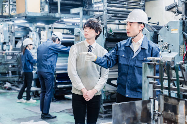 istock Male students touring the factory 1472099686
