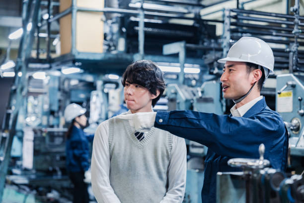 istock Male students touring the factory 1472099696