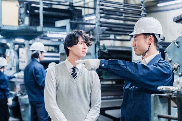 istock Male students touring the factory 1472099751