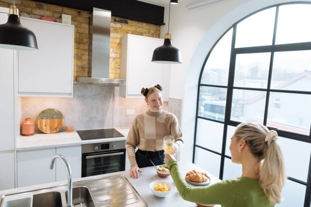 istock Two friends enjoying preparing dinner at home 1472100305