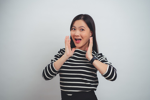 Asian woman happy smiling excited with empty copy space for advertising and looking at camera isolated on white background.