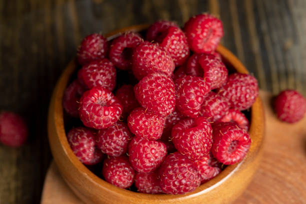 istock Harvested red ripe raspberries in the kitchen 1472100718