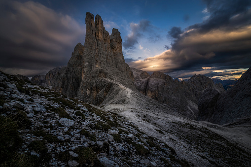 Picture of the Torri del Vajolet mountain range in Trentino, Italy at sunset over a cloudy sky