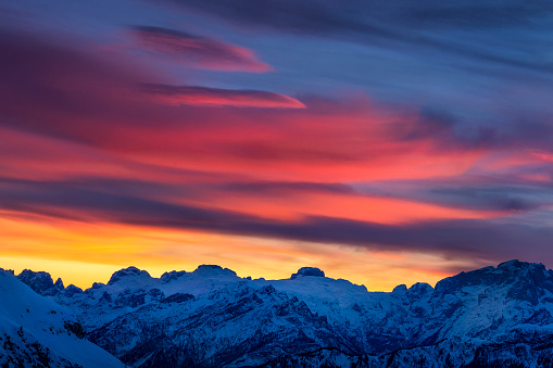 Picture of some spectacular colorful clouds over Mount Marmolada at sunset in Cortina d'Ampezzo, Italy