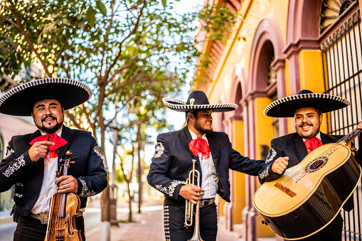 Group of traditional mariachis walking at the historic district