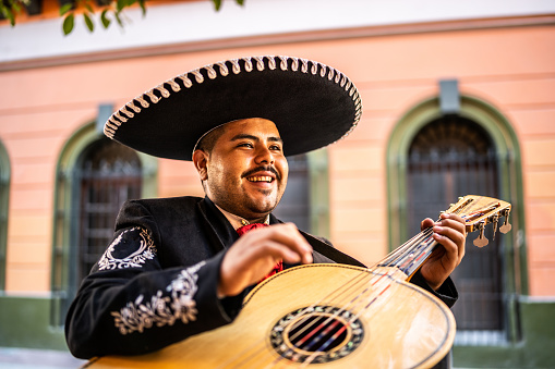 Traditional mariachi guitarist playing at the historic district