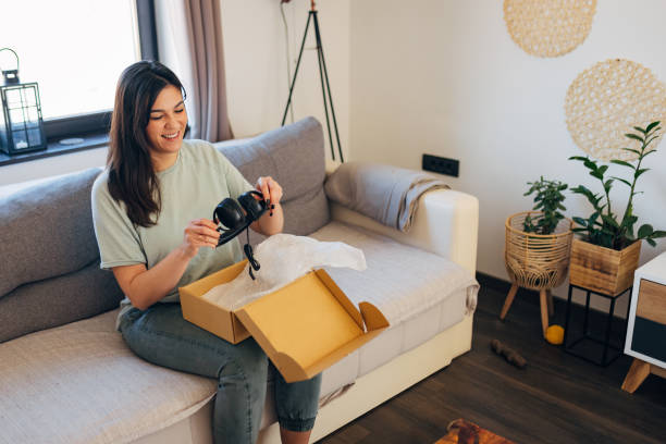 istock Cheerful female client unboxing web shop order, satisfied with customer service 1472104102