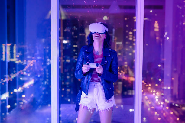 istock Cheerful woman exploring VR experience with headset and console in apartment 1472104418