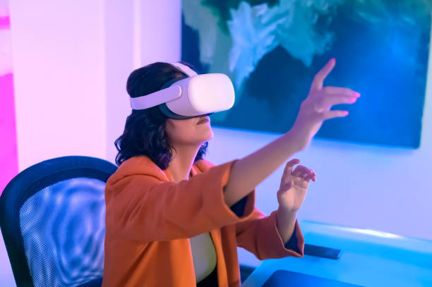 istock Businesswoman enjoying VR experience with headset in office 1472104531
