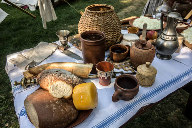 istock Rustic table with loaves of bread and cheese heads 1472105651