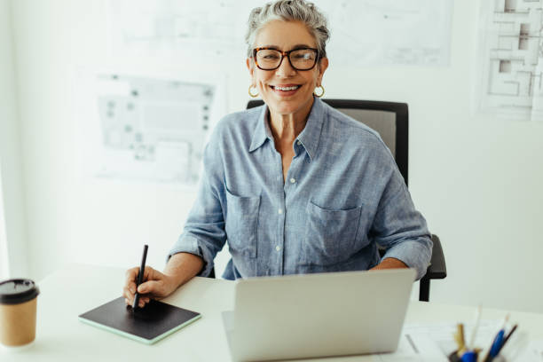 istock Successful female designer drawing high quality designs using a graphics tablet and a laptop 1472107543