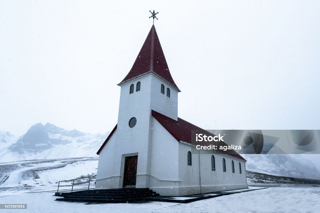 Reyniskirkja Church on the southern coast of Vik, Iceland on a cloudy snow winter day Adventure Stock Photo