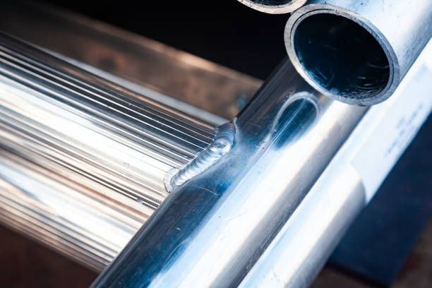 Welded new aluminum pipes close-up.