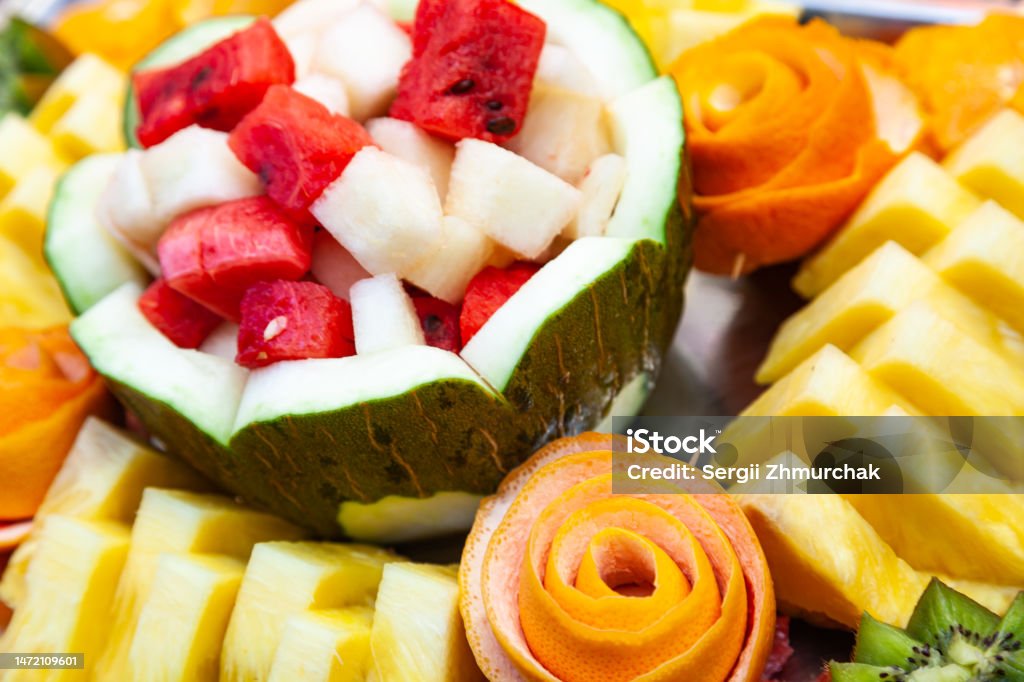 Decorative fruit salad on a fruity background. Sliced watermelon, melon, pineapple and grapefruit. Appetizer Stock Photo