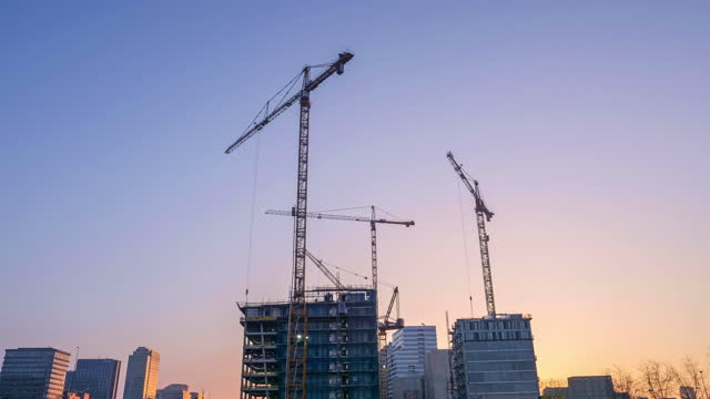 Construction site with cranes at dawn