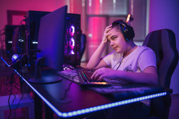 istock Teenager addicted to video games playing on a computer. 1472110574