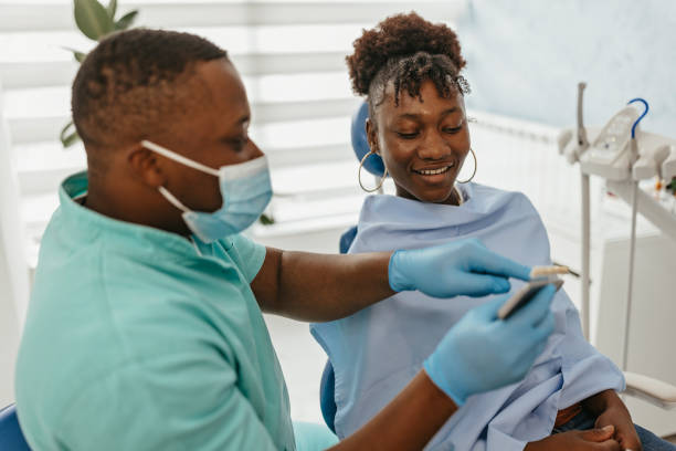 istock Smiling patient at dental treatment 1472110908