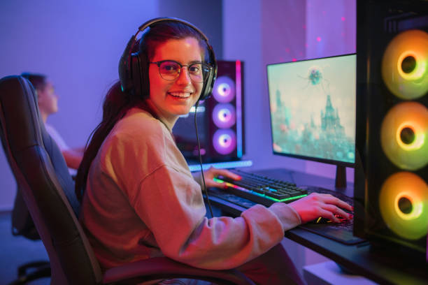 istock Smiling female gamer playing video games. 1472110923