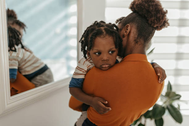 istock Mother consoling the kid at doctor's office 1472111140