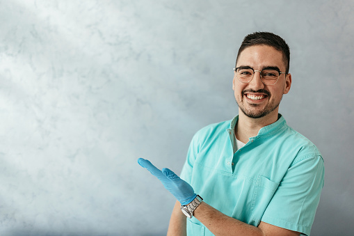 Portrait of proud  young smiling male dentist