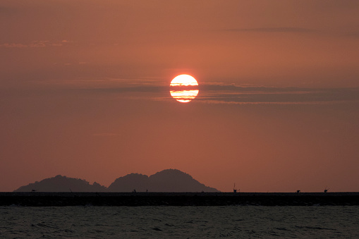Beautiful sunset hidden behind the hill seen from the beach of Ulee Lheu Aceh Indonesia