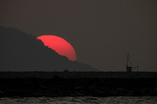 Beautiful sunset hidden behind the hill seen from the beach of Ulee Lheu Aceh Indonesia