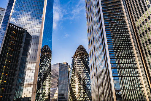 Low angle view looking up at tall office buildings in UK financial district