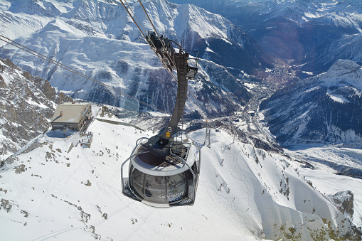 Courmayeur, Italy - February 20, 2020: Alpine cable car Skyway Monte Bianco from Courmayeur to Punta Helbronner with scenic views of Mont Blanc massif and Alps. Aosta Valley.