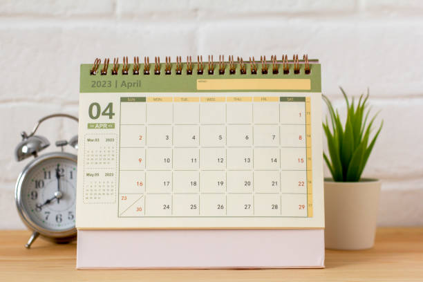 istock Hello April.Desktop calendar for April 2023 on the table. 1472115423
