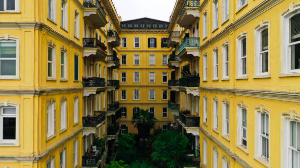 yellow apartment and trees high resolution photo taken with drone yellow apartment and trees high resolution photo taken with drone unicef vintage stock pictures, royalty-free photos & images
