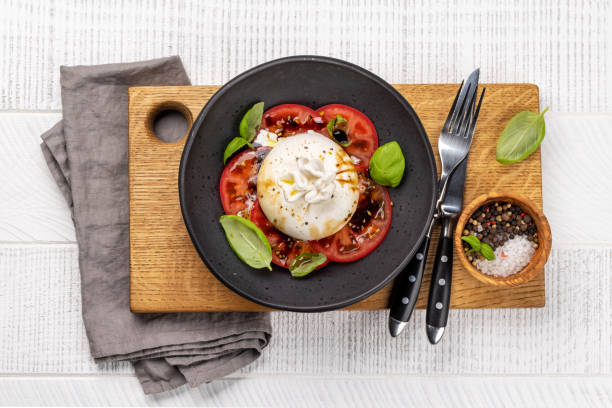istock Burrata cheese, tomatoes and basil 1472118065
