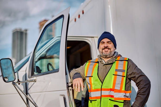 istock Happy professional truck driver looking at camera. 1472119061