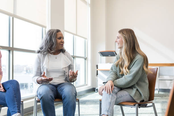 istock Therapist gestures while talking to the young adult female 1472119733