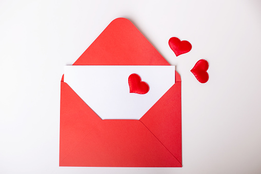 Red envelope with hearts and copy space, Valentine's day background, love and romance.