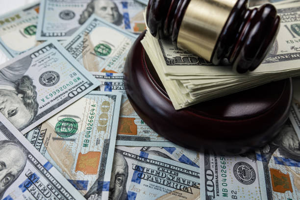 istock wooden hammer on one hundred dollar bill 1472126678