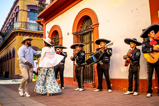 Mid adult couple dancing mariachi music at the historic district