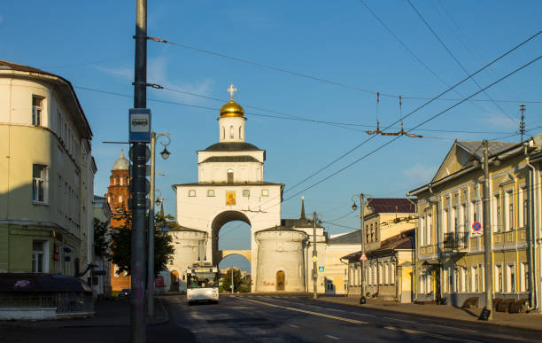 golden gate with a shiny dome in the old town of Vladimir white stone golden gate with a shiny dome in the old town of Vladimir on a sunny summer august day against a blue clear sky golden gate vladimir stock pictures, royalty-free photos & images