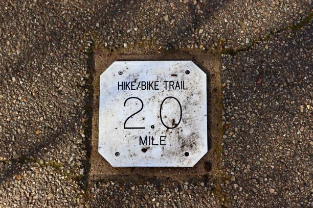 A close view of the gray metal mile marker sign.