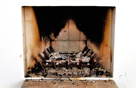 The ashes of the burnt wood in the fireplace in the apartment