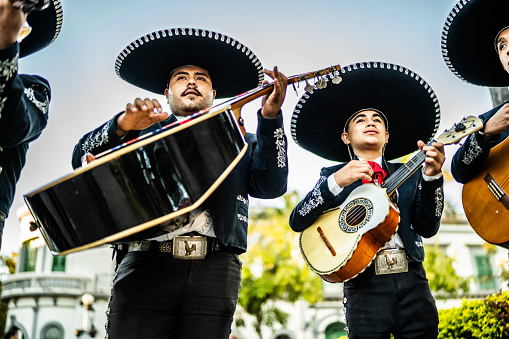 Group of traditional mariachis playing outdoors