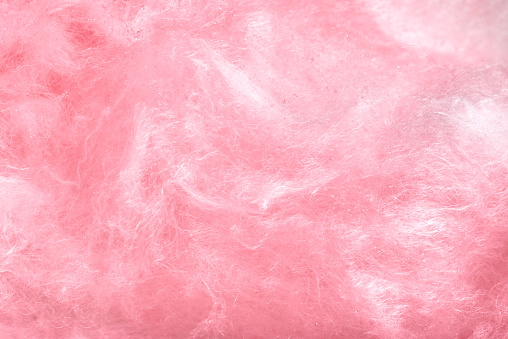 Macro photo of sweet pink cotton candy, backdrop.