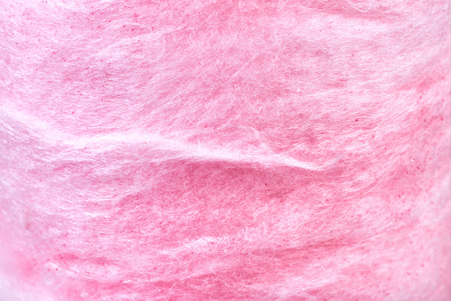 Macro photo of sweet pink cotton candy, backdrop.