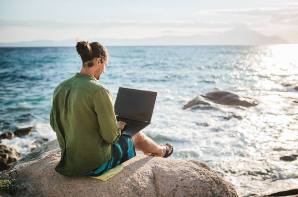 istock Young digital nomad man working by the sea 1472132373