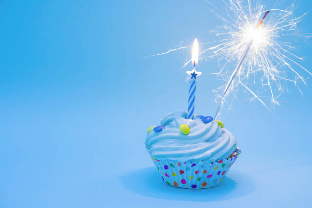 istock Birthday cupcake blue with sparkler 1472133730