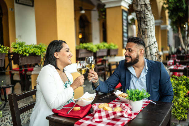 istock Married couple making a toast at a dinner celebration outdoors 1472133946