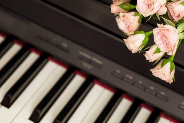 istock Romantic holiday composition with pink roses on piano 1472135314