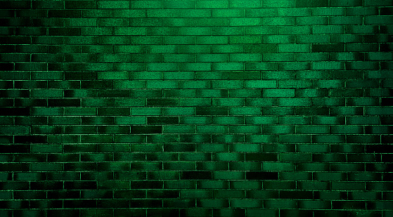 abstract green brick wall texture used as background, brick wall texture for design. empty, old, green brick background with copy space. product showcase spotlight background with green neon light.