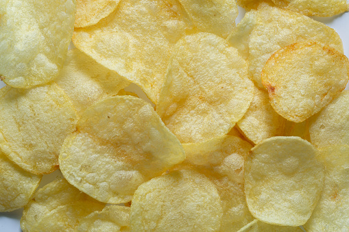 Macro Potato Snacks,Crispy potato chips texture background top view,abstract background of potato chips food texture