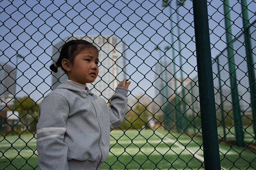 Asian little girl is sad not to play sports
